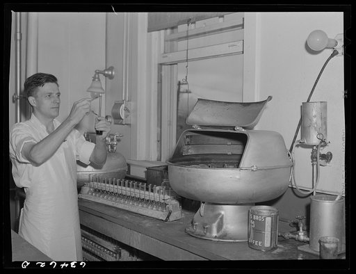 Determining butterfat content of samples of milk in laboratory of creamery. Antigo, Wisconsin