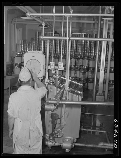 Checking temperature of milk being pasteurized. Antigo, Wisconsin