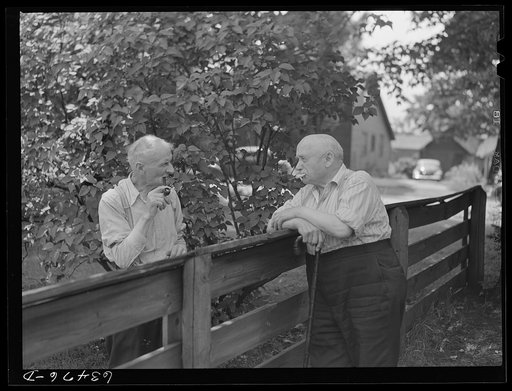 Residents of copper range town talking over back fence. Laurium, Michigan