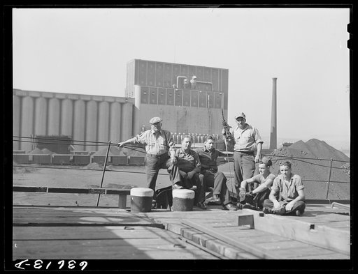 Captain (on the left) and part of the crew of the "James Watt," Great Lakes boat which is being loaded with wheat to take to Buffalo. Duluth, Minnesota