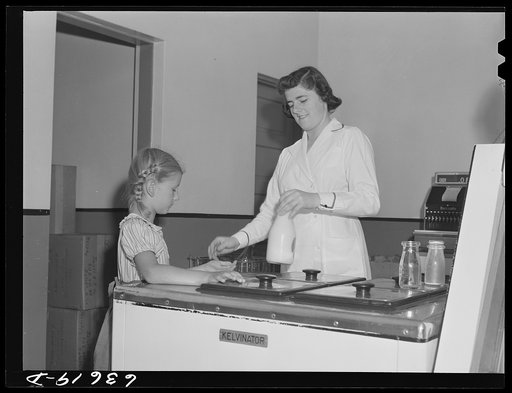 Child buying bottle of milk. Duluth Milk Company. Duluth, Minnesota