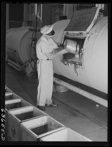 Adding salt to butter in churn. Portage, Wisconsin