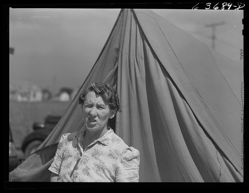 Mrs. Ash, wife of defense worker. They are living in a tent beside the foundation of their new home which they are building themselves. Outskirts of Detroit, Michigan