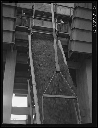 Untitled photo, possibly related to: Iron ore going down chute into hold of boat. Allouez, Wisconsin