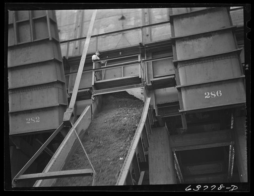 Iron ore going down chute into hold of boat. Allouez, Wisconsin