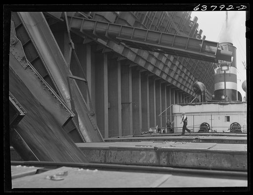 Untitled photo, possibly related to: Loading iron ore into hold of boat. First mate directing operations. Allouez, Wisconsin