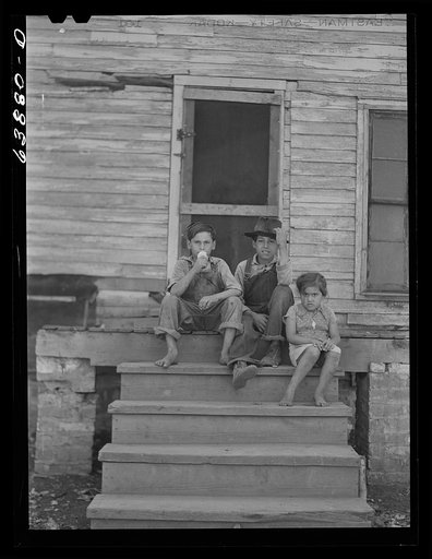 Children of Mexican sugar beet workers on porch of one of the houses at Saginaw Farms, Michigan
