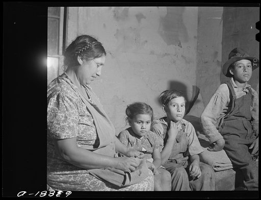 Untitled photo, possibly related to: Children of Mexican sugar beet workers on porch of one of the houses at Saginaw Farms, Michigan