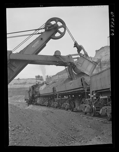 Untitled photo, possibly related to: Loading cars with giant power shovel at Danube iron mine near Bovey, Minnesota