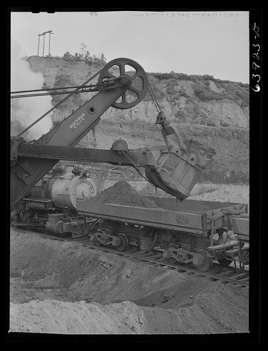 Untitled photo, possibly related to: Loading cars with giant power shovel at Danube iron mine near Bovey, Minnesota