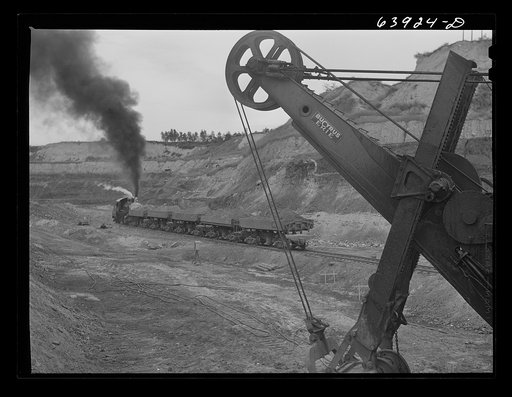 Loading cars with giant power shovel at Danube iron mine near Bovey, Minnesota