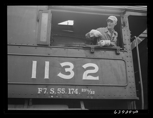 Railroad engineer who brings ore cars up from open pit mine to concentration plant near Bovey, Minnesota