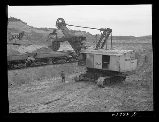 Untitled photo, possibly related to: Loading seventy ton cars with iron ore, Mahoning pit, Hibbing, Minnesota