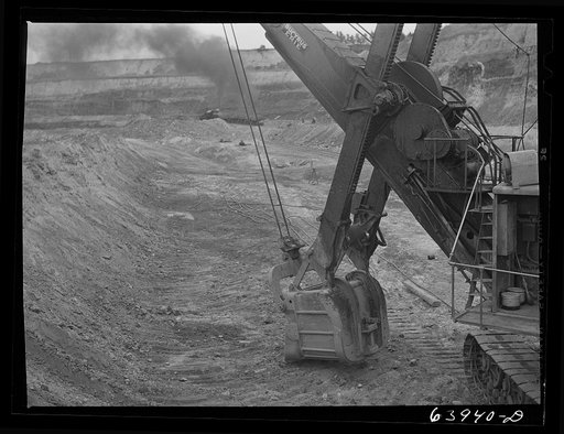 Untitled photo, possibly related to: Loading seventy ton cars with iron ore, Mahoning pit, Hibbing, Minnesota