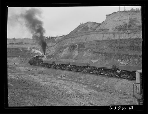 Untitled photo, possibly related to: Loading cars with giant power shovel at Danube iron mine near Bovey, Minnesota