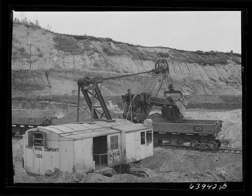 Untitled photo, possibly related to: Loading seventy ton cars with iron ore, Mahoning pit, Hibbing, Minnesota