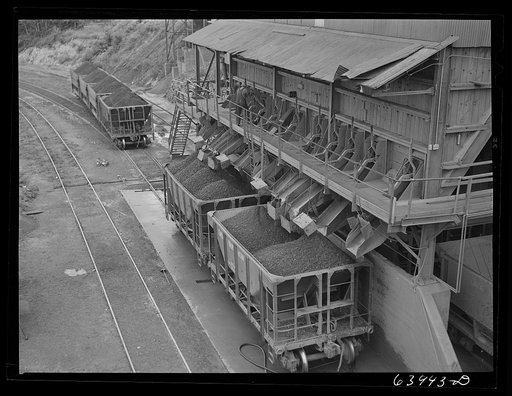 Untitled photo, possibly related to: Washed ore being loaded into seventy ton cars for shipment to Duluth-Superior ore docks. Concentration plant at Bovey, Minnesota