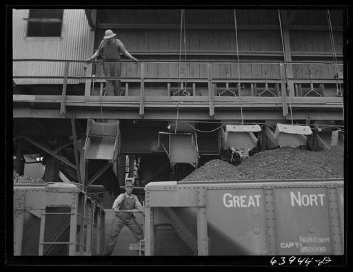 Washed ore being loaded into seventy ton cars for shipment to Duluth-Superior ore docks. Concentration plant at Bovey, Minnesota