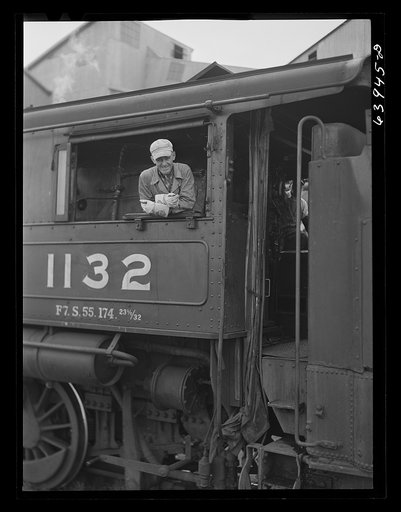 Untitled photo, possibly related to: Railroad engineer who brings ore cars up from open pit mine to concentration plant near Bovey, Minnesota