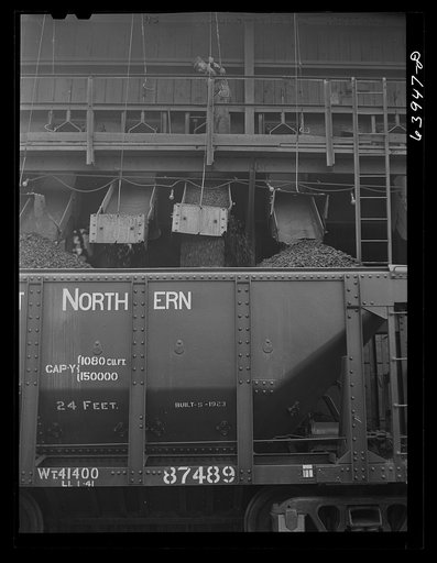 Untitled photo, possibly related to: Washed ore being loaded into seventy ton cars for shipment to Duluth-Superior ore docks. Concentration plant at Bovey, Minnesota