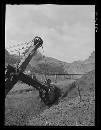 Untitled photo, possibly related to: Loading seventy ton cars with iron ore, Mahoning pit, Hibbing, Minnesota