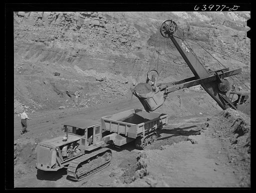 Untitled photo, possibly related to: Loading truck with iron ore at the Albany mine near Hibbing, Minnesota. Use of trucks was initiated in this mine two years ago and railroad tracks removed
