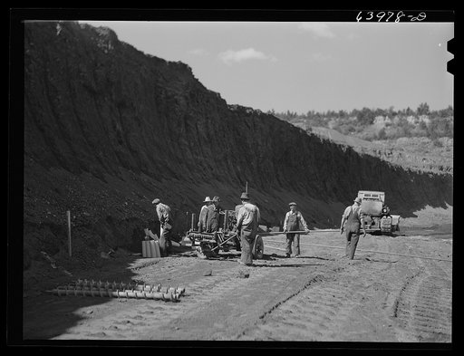 Untitled photo, possibly related to: Blasting crew boring into vein with horizontal drill for dynamiting. Mahoning pit, Hibbing, Minnesota