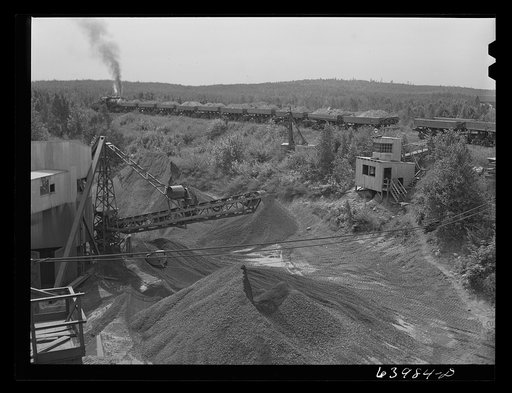 Untitled photo, possibly related to: Loading cars with giant power shovel at Danube iron mine near Bovey, Minnesota