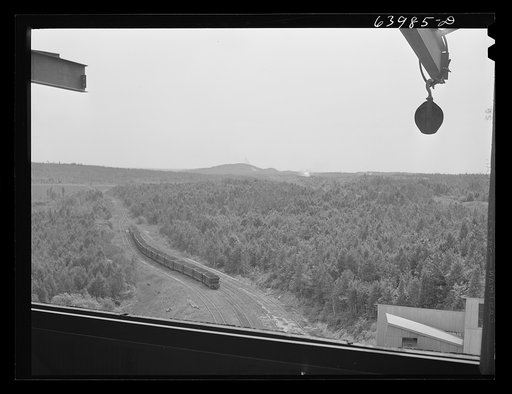 Untitled photo, possibly related to: Operating releases which control chutes in loading railroad cars with ore at concentration plant for Danube mine near Bovey, Minnesota