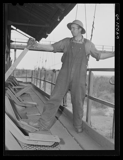 Operating releases which control chutes in loading railroad cars with ore at concentration plant for Danube mine near Bovey, Minnesota