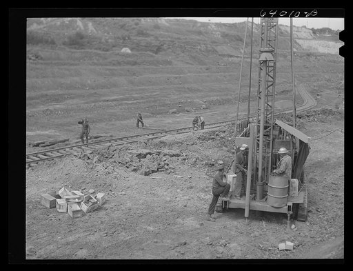 Vertial drill boring hole for blasting crew. Mahoning pit, Hibbing, Minnesota