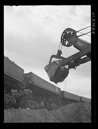 Loading iron ore into seventy ton cars. Danube Mine near Bovey, Minnesota