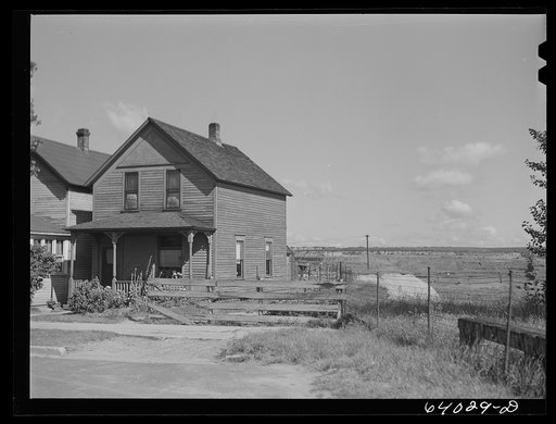 Untitled photo, possibly related to: House in North Hibbing, Minnesota on the edge of the world's largest open pit iron mine. Houses in this section are being demolished daily as mining operations expand