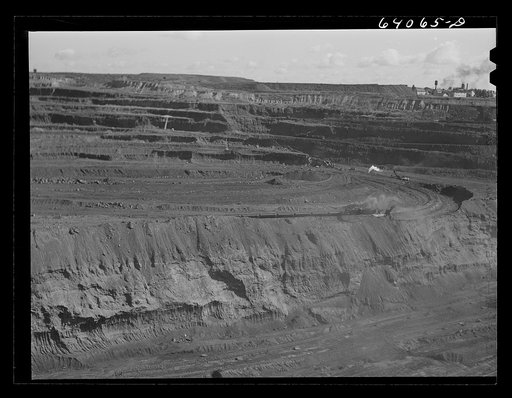 Untitled photo, possibly related to: World's largest open pit iron mine at Hibbing, Minnesota. The pit is two and a half miles long, three quarters of a mile wide, four hundred feet deep