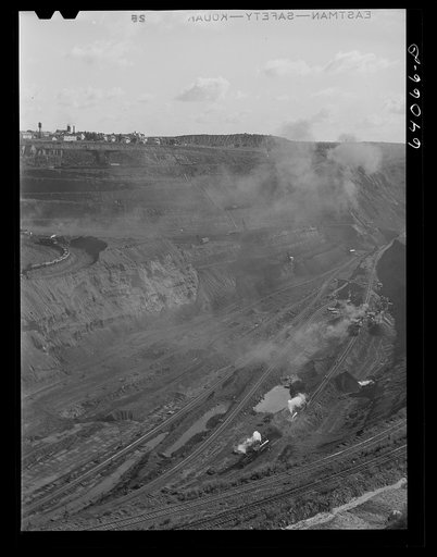 Untitled photo, possibly related to: World's largest open pit iron mine at Hibbing, Minnesota. The pit is two and a half miles long, three quarters of a mile wide, four hundred feet deep