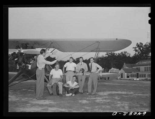 Untitled photo, possibly related to: Instructor with group of student flyers under Civilian Pilot Training Program. Congressional Airport. Rockville, Maryland