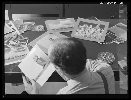 Untitled photo, possibly related to: Washington, D.C. Preparing the defense bond sales photomural, to be installed in the Grand Central terminal, New York, in the visual unit of the FSA (Farm Security Administration). Edwin Rosskam selecting from the files pictures to be used in the center