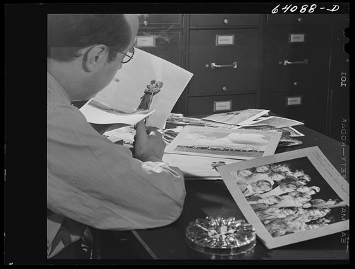 Untitled photo, possibly related to: Washington, D.C. Preparing the defense bond sales photomural, to be installed in the Grand Central terminal, New York, in the visual unit of the FSA (Farm Security Administration). Edwin Rosskam selecting from the files pictures to be used in the center