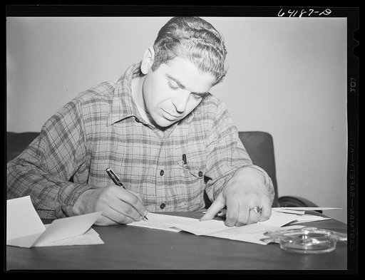 Untitled photo, possibly related to: Defense worker writing a letter home in lobby of one of the FSA (Farm Security Administration) dormitories for defense workers. Aberdeen, Maryland