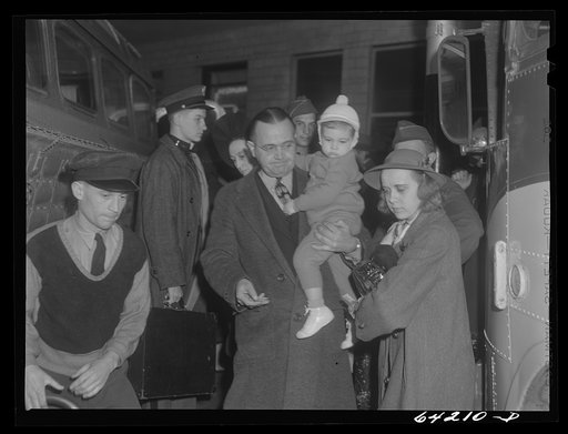 Washington, D.C. Greyhound bus terminal on the day before Christmas. Passengers getting off a bus which has arrived at the terminal