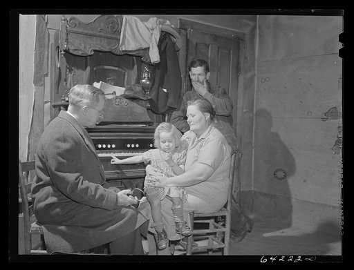 Untitled photo, possibly related to: Scott County, Missouri. Doctor visits sick child at home