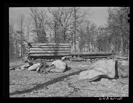 Newton County, Missouri. Camp Crowder area. Deserted home of Ozark farmer; his land was bought by the Army. Neighbors who have not yet left the area come in and haul logs from his cabin