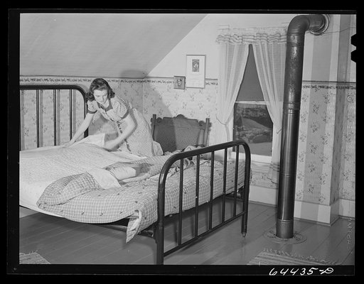 Meeker County, Minnesota. Elaine McCormick, one of the McRaith grandchildren, making the beds in the morning before the school bus comes