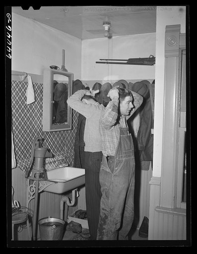 Meeker County, Minnesota. Washing up for dinner on Pat McRaith's farm