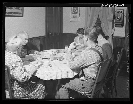 Meeker County, Minnesota. Old Mr. and Mrs. McRaith, Pat, the hired man, and one of the grandchildren at lunch