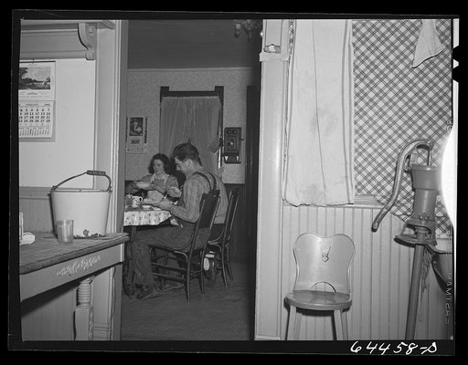 Untitled photo, possibly related to: Meeker County, Minnesota. Old Mr. and Mrs. McRaith, Pat, the hired man, and one of the grandchildren at lunch