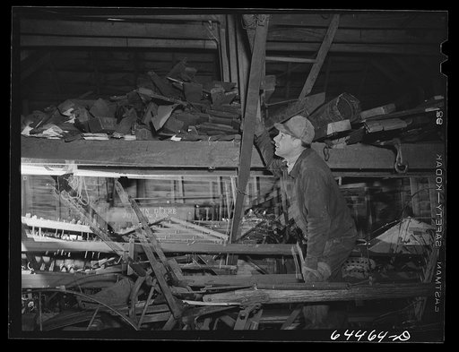 Meeker County, Minnesota. Pat McRaith looking over machinery in his machine shed
