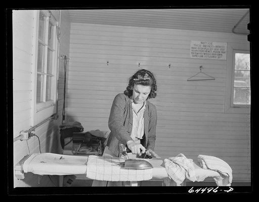 Burlington, Iowa. Acres unit, FSA (Farm Security Administration) trailer camp. Women ironing in utility building for workers at Burlington ordnance plant