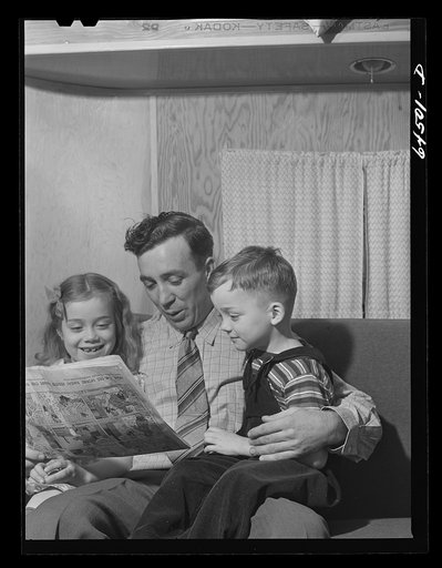 Burlington, Iowa. Cecil Patrick reading the funnies to his kids. FSA (Farm Security Administration) trailer camp for workers at Burlington ordnance plant