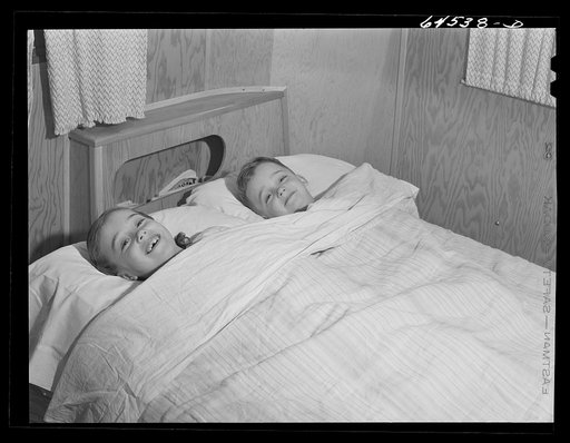 Burlington, Iowa. Acres unit, FSA (Farm Security Administration) trailer camp. Cecil Patrick's kids in bed in their trailer for workers at Burlington ordnance plant